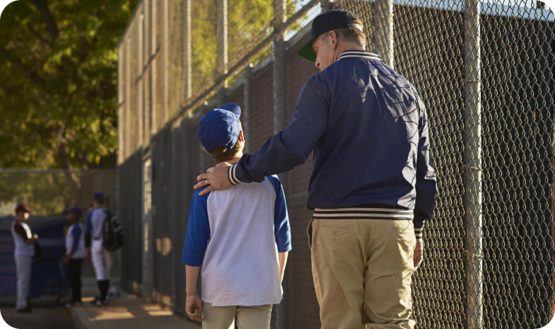 baseball coach with arm around player