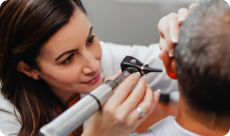 Beltone specialist examining a patients ear